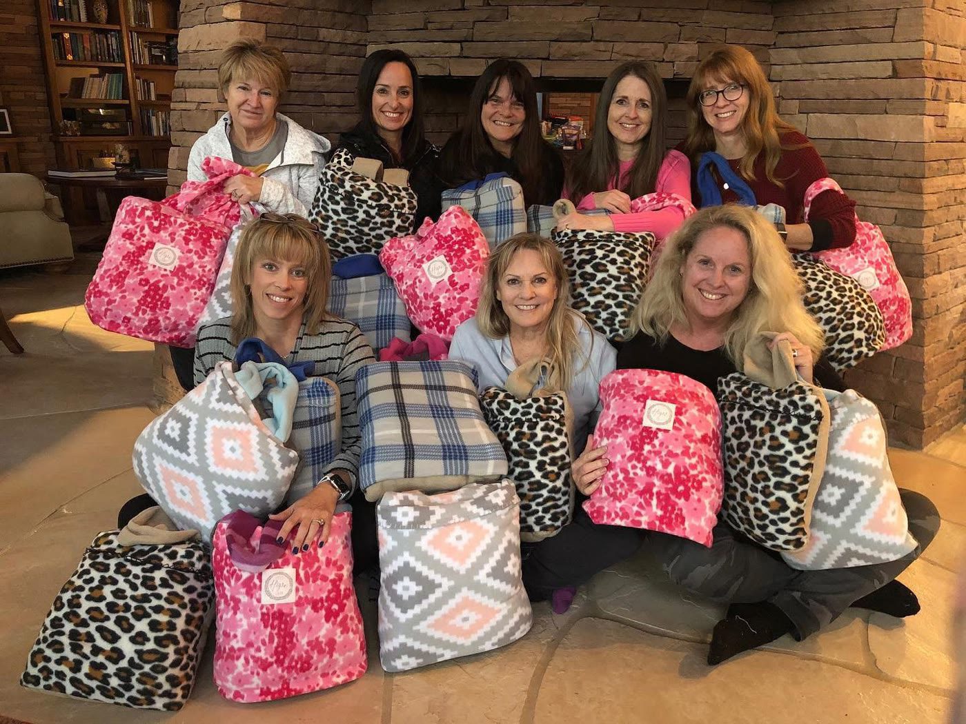 Cece's Hope Center volunteers with handmade bags of donated essentials