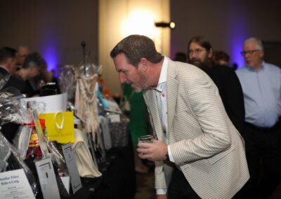 A guest browsing the Night of Light silent auction tables