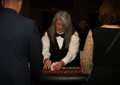 A dealer runs a card game at the Night of Light casino tables